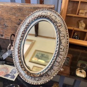 Beautiful old wooden oval mirror in muted tones